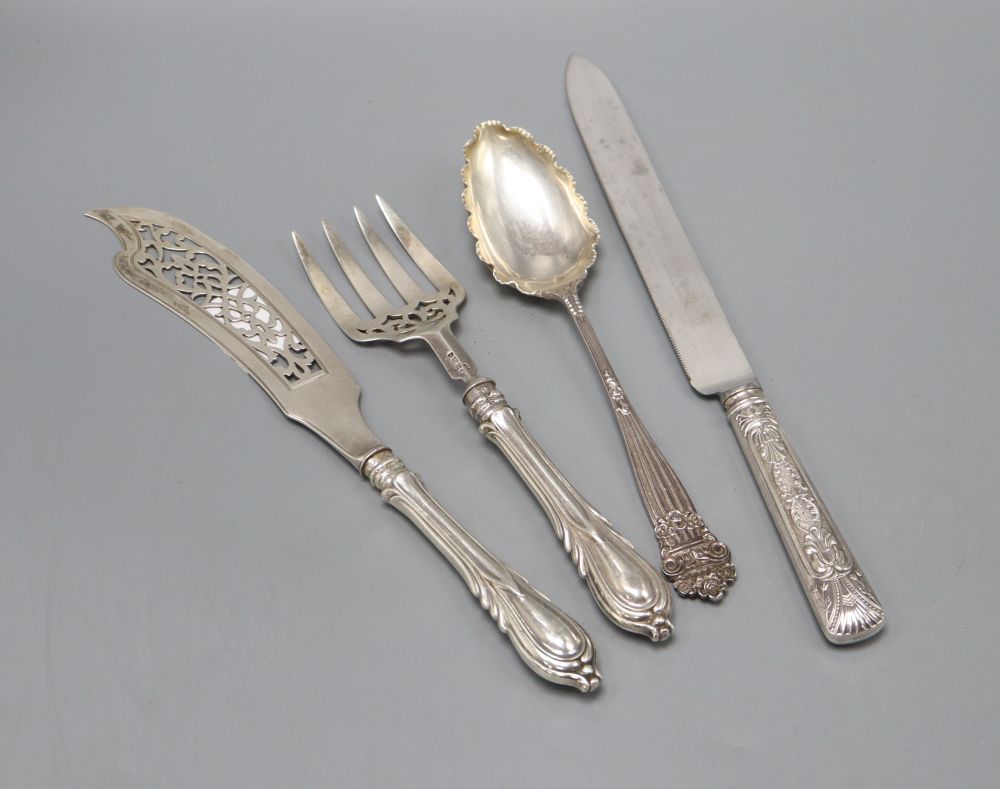 A pair of Victorian silver fish servers with weighted handles, a later dessert serving spoon and a silver handled bread knife